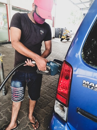 Customer filling up their car with gasoline at Gasolinera Bacum.