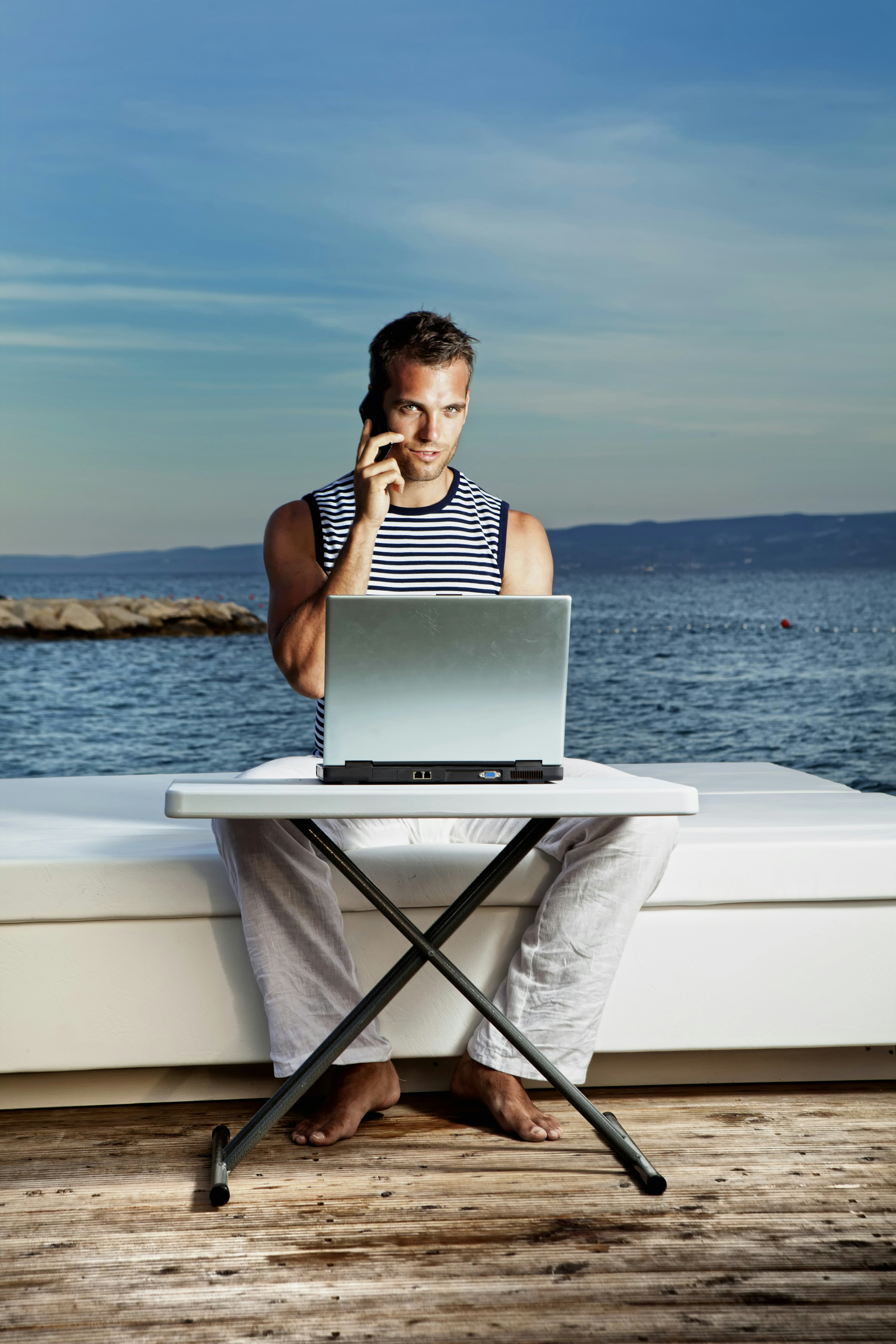 Man with the laptop On the Phone Outdoors