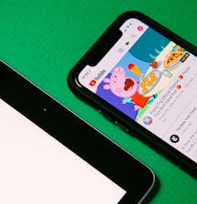 black android smartphone on green table