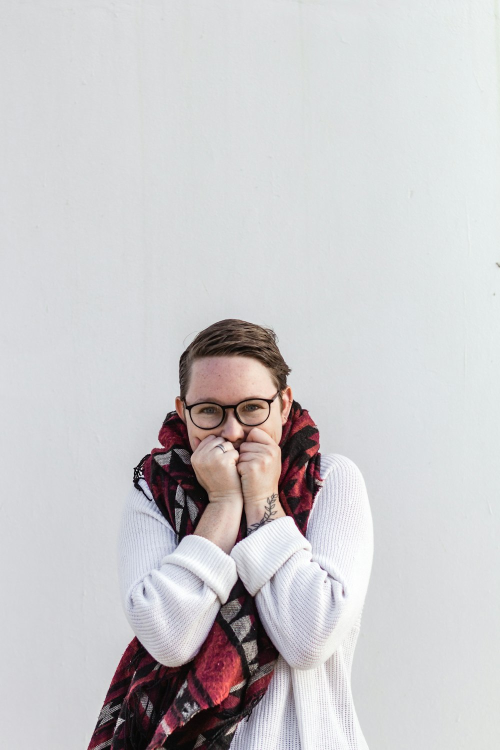 woman in white sweater wearing eyeglasses