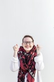 payday is here - woman with glasses and red scarf is doing her happy dance