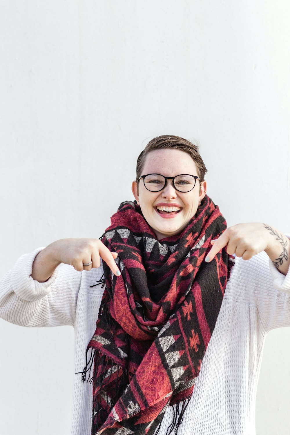 woman in white long sleeve shirt wearing red scarf and black framed eyeglasses