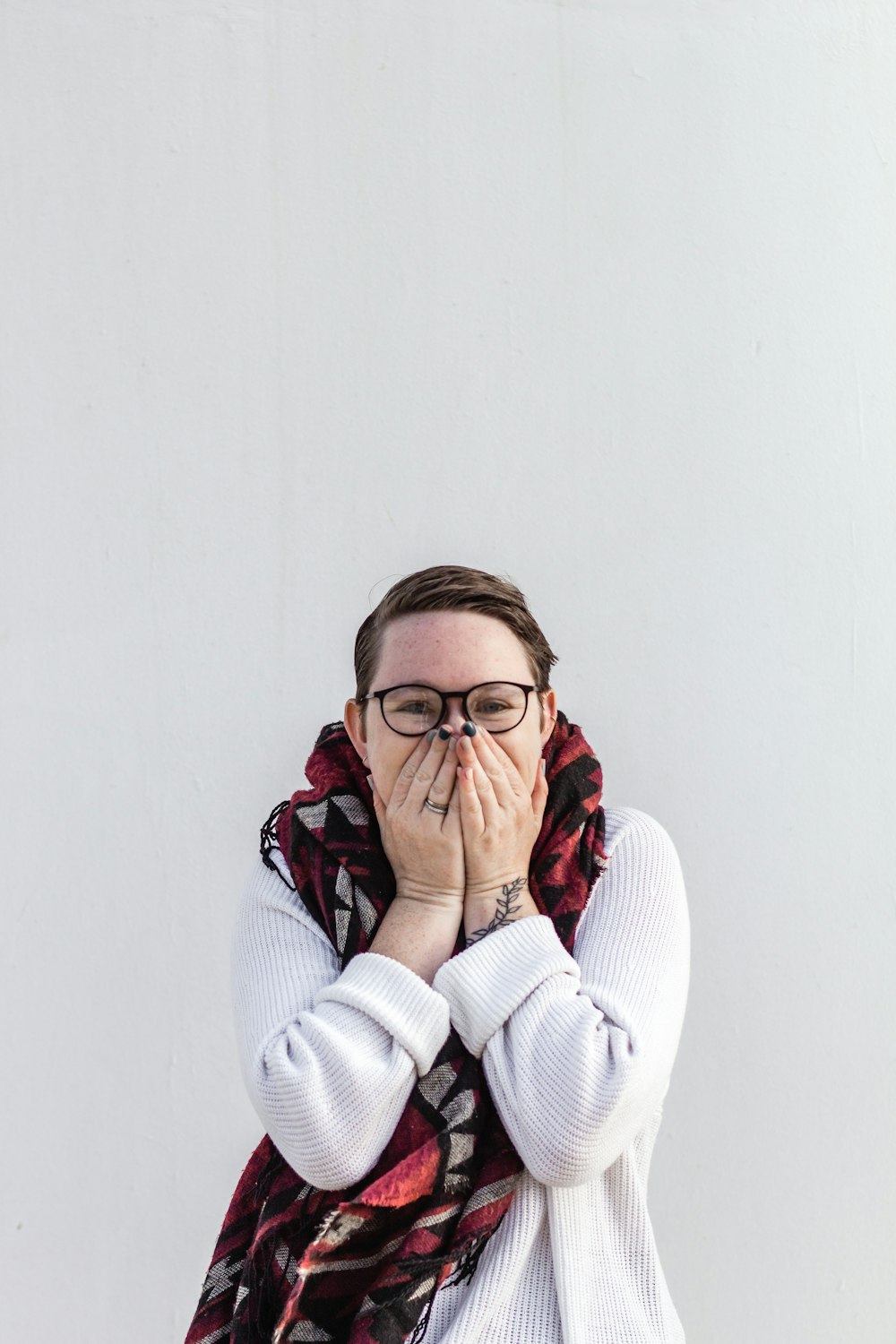 woman in white sweater wearing eyeglasses