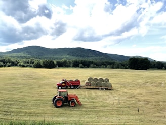 A scenic view of a tow truck in a rural area.