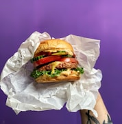 burger on white paper bag