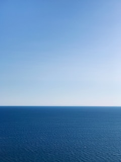 blue ocean under blue sky during daytime
