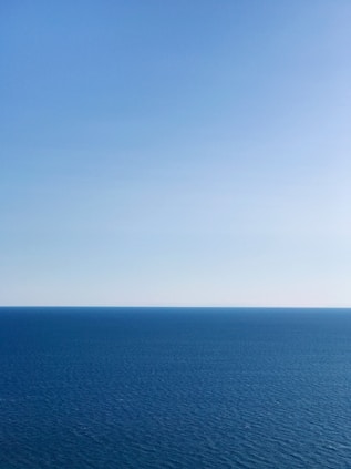 blue ocean under blue sky during daytime
