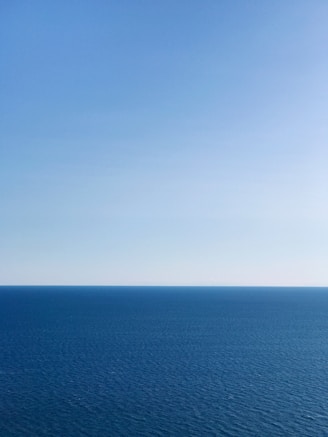 blue ocean under blue sky during daytime