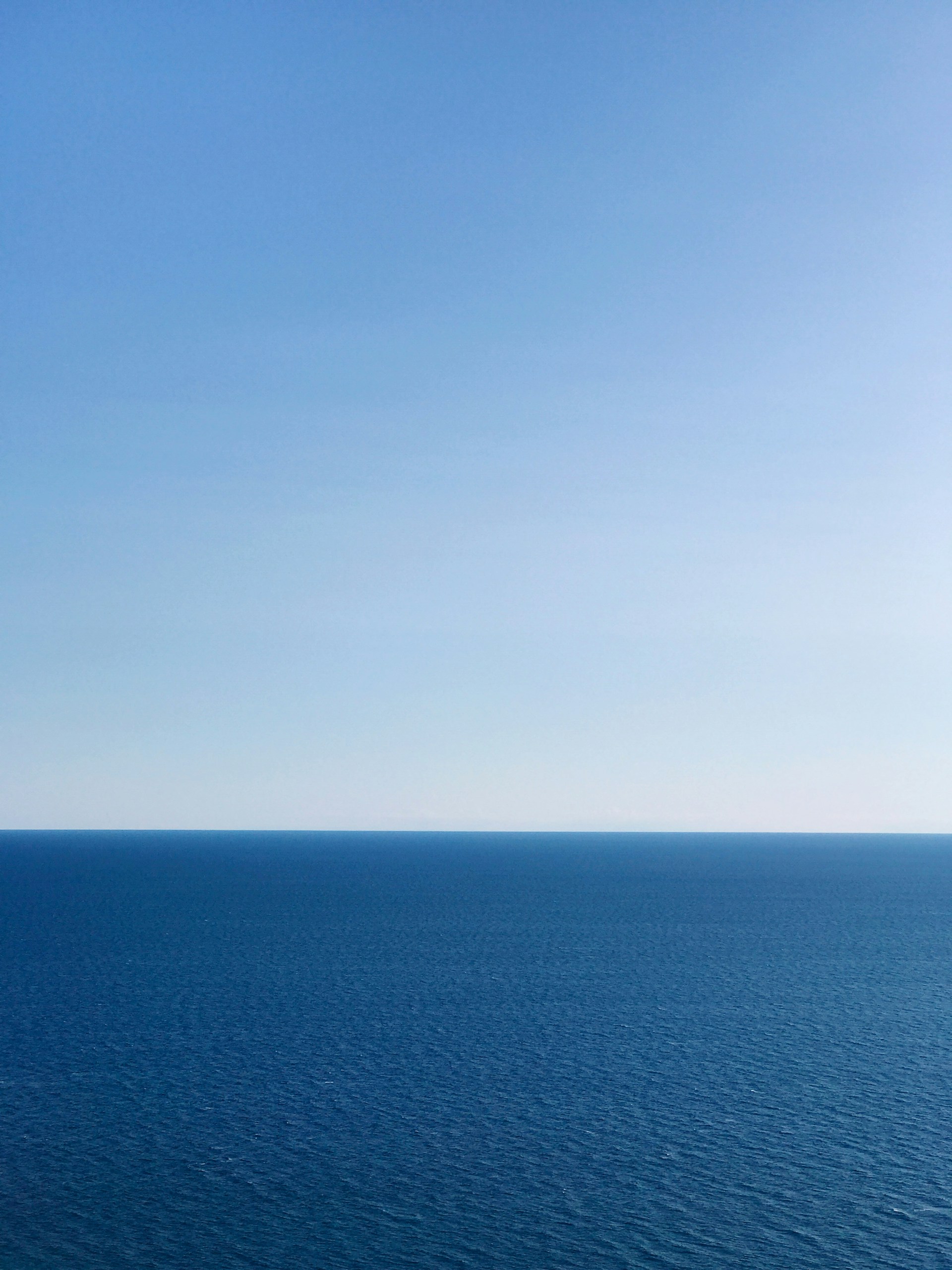 blue ocean under blue sky during daytime