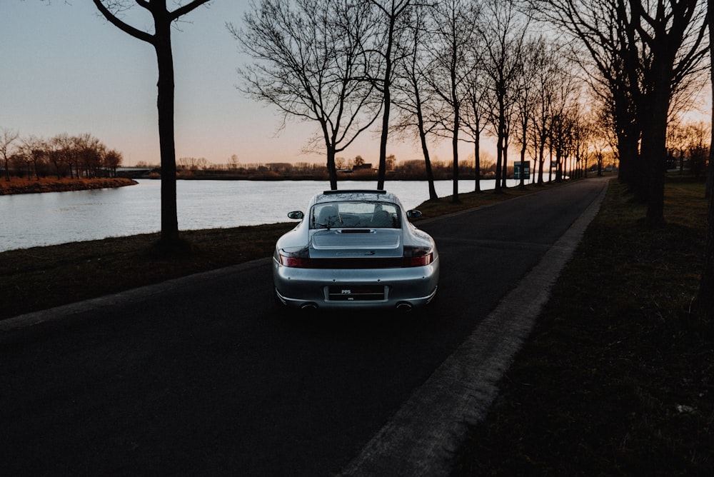 white car parked on sidewalk during sunset