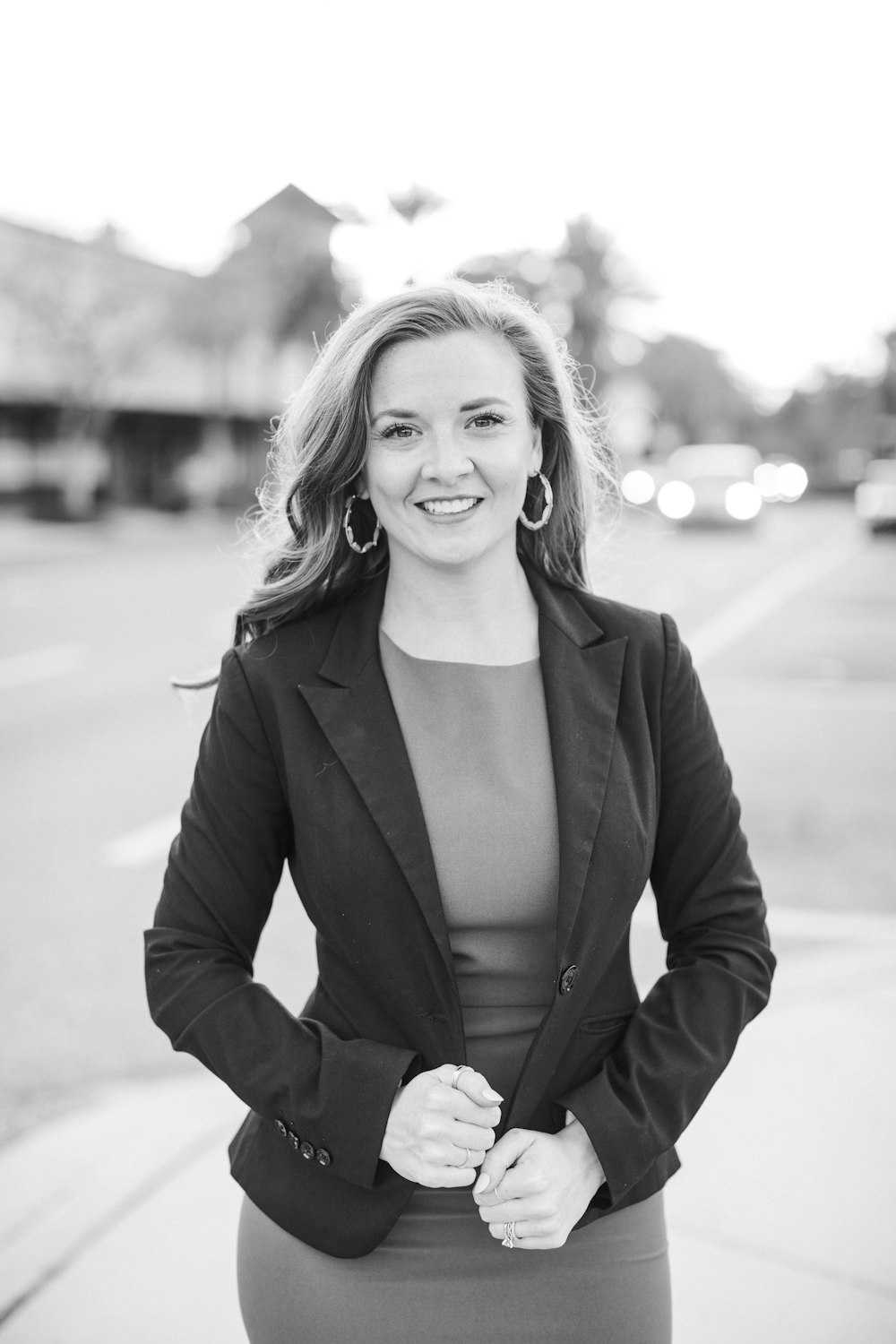 woman in black blazer smiling