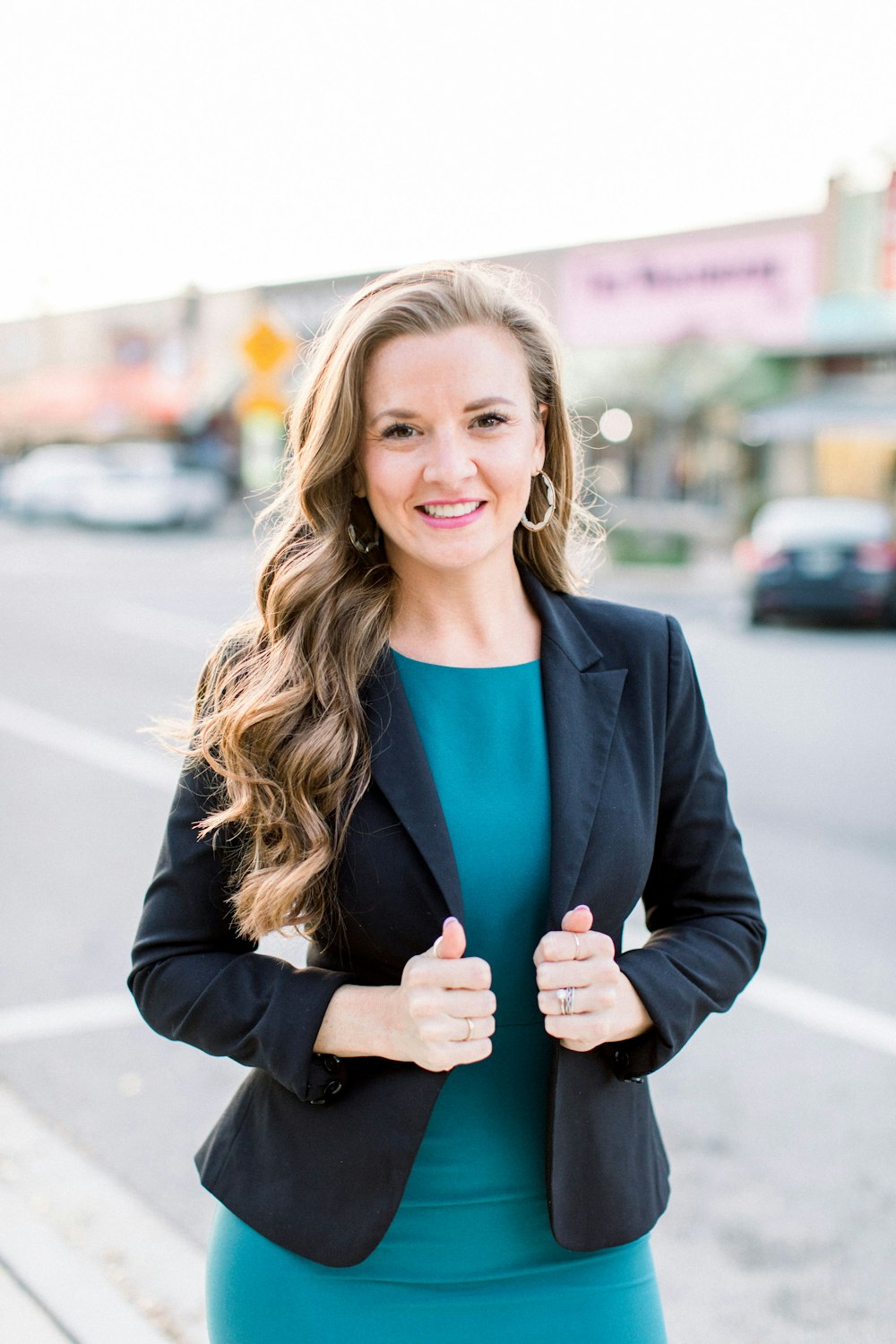 woman in black blazer smiling