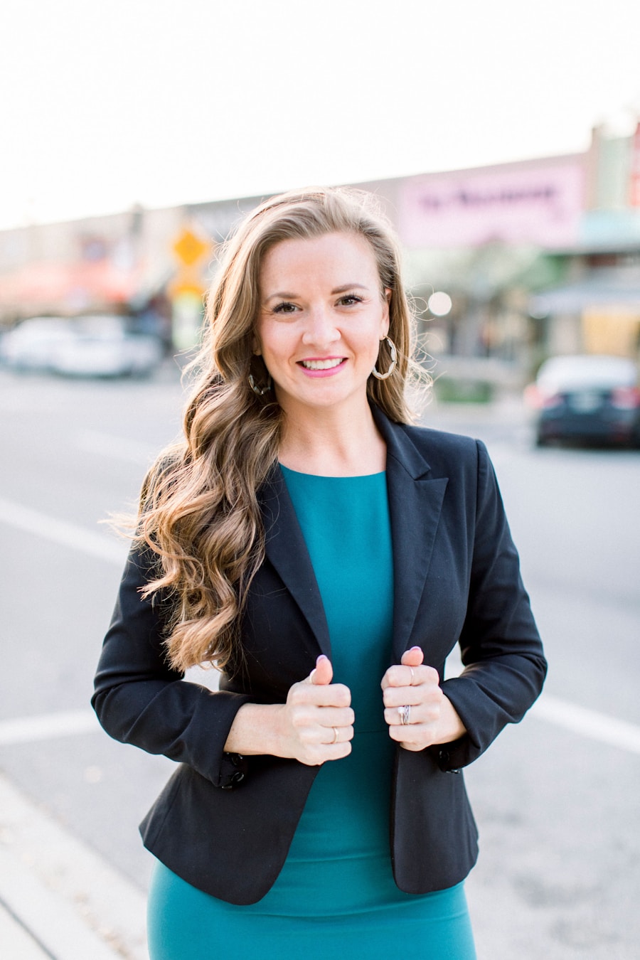Broker standing on a small-town main street in a dark blazer