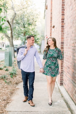 photography poses for couples,how to photograph couple walking, couple smiling at each other, love, couple holding hands, learn more about the models, alex sanfilippo and alecia sanfilippo @ podpros.com; man and woman standing beside brick wall during daytime