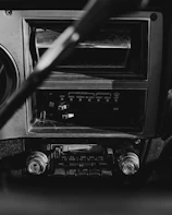 Close-up of a retro dashboard with glowing dials and a cassette player.