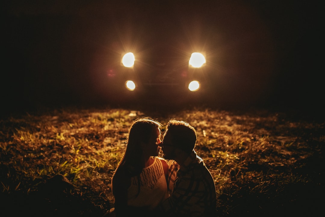 man and woman kissing during night time