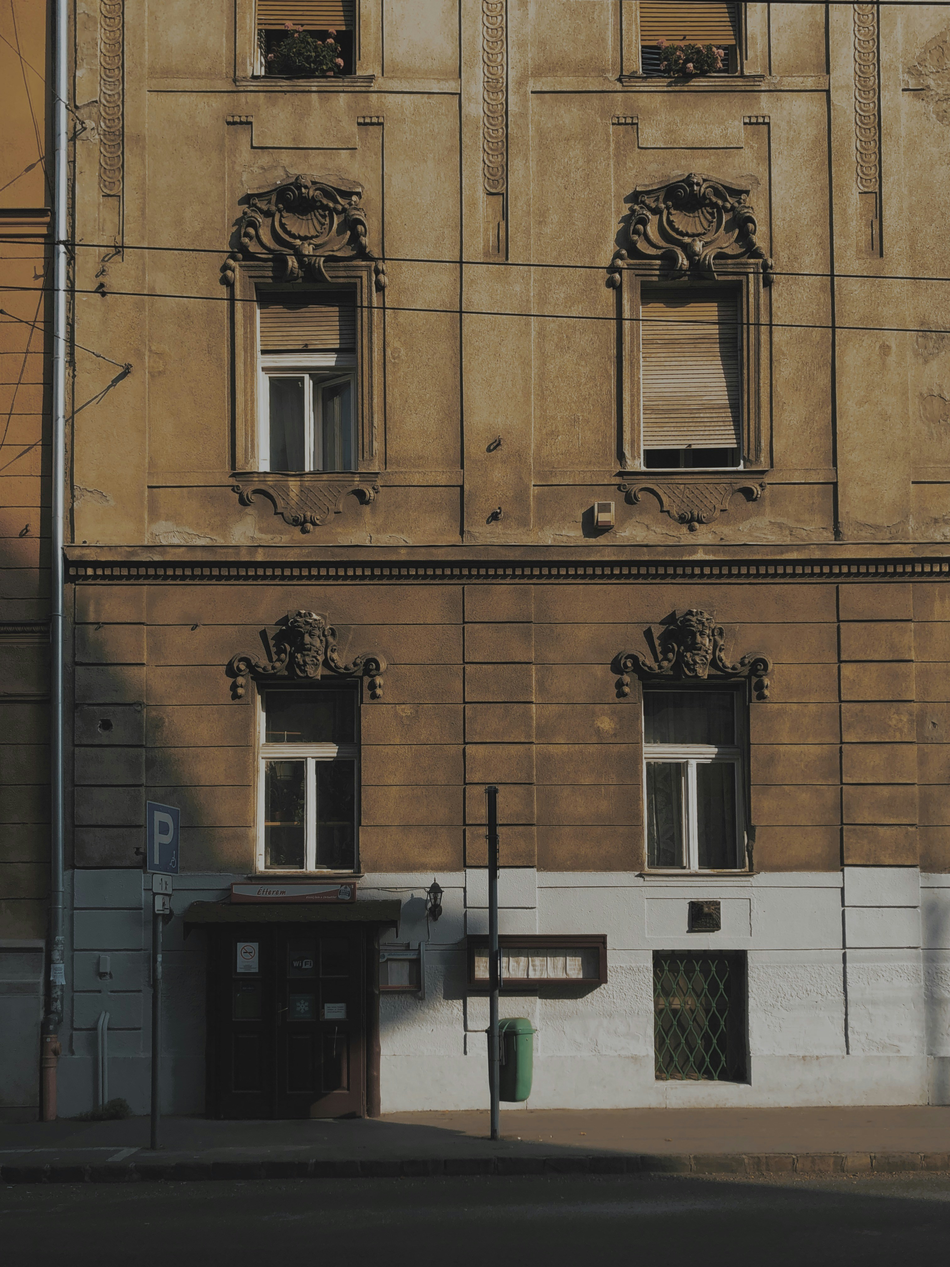 brown concrete building with black steel gate