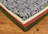 Stacks of soft, patterned textiles folded on a wooden table.