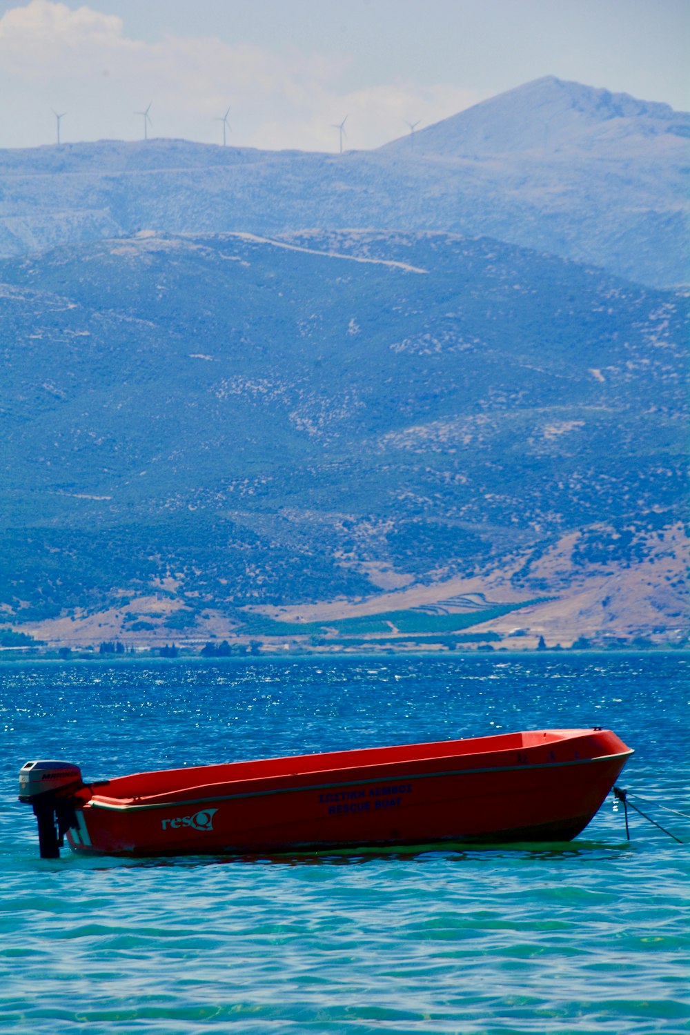 red boat on body of water during daytime