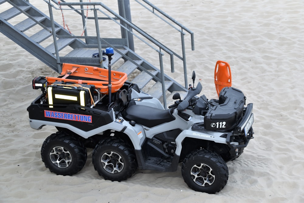 orange and black atv on snow covered ground