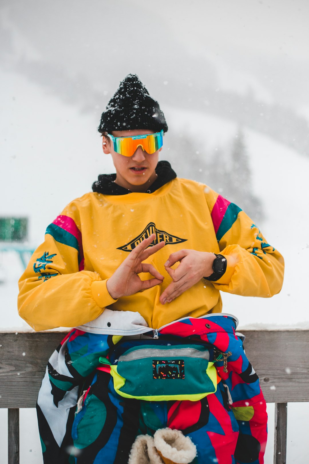 man in yellow jacket wearing blue helmet and goggles