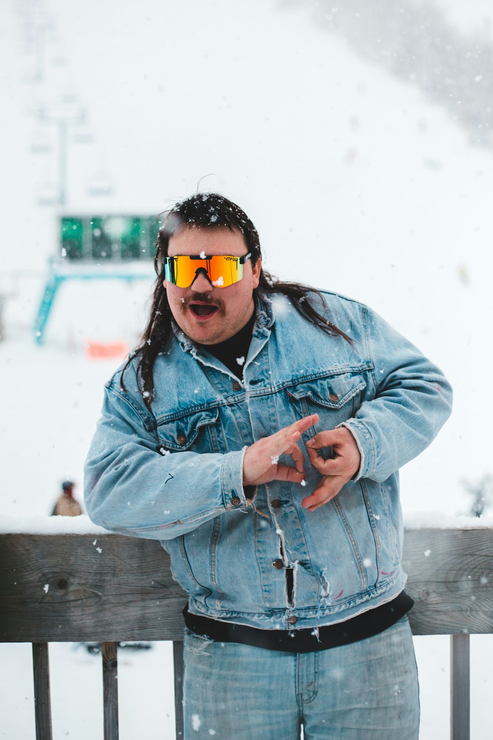 woman in blue denim jacket wearing yellow sunglasses