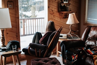 woman sitting on brown leather armchair