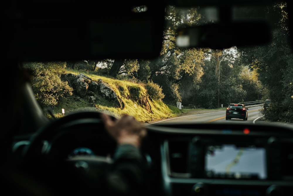 man in black jacket driving car during daytime