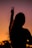 silhouette of woman raising her right hand