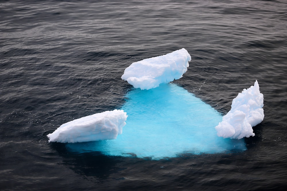 white ice on body of water during daytime