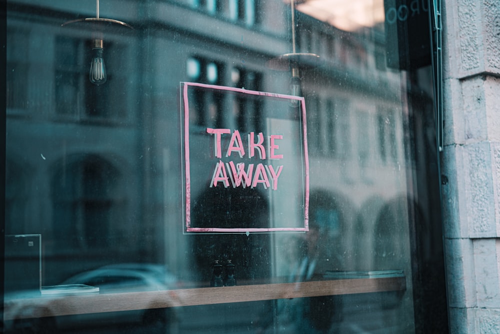a window with a sign that says take away