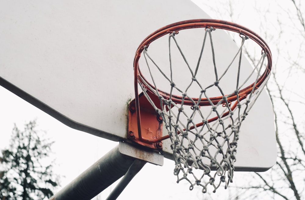 orange basketball hoop on white wall