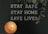 A black letter board displays the message 'STAY SAFE STAY HOME SAVE LIVES.' A lit candle is positioned in the lower left corner, casting a warm glow. Dried eucalyptus leaves hang from the top right corner, adding a natural element.