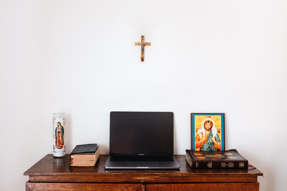 black laptop computer on brown wooden table