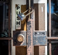 brown wooden door with padlock