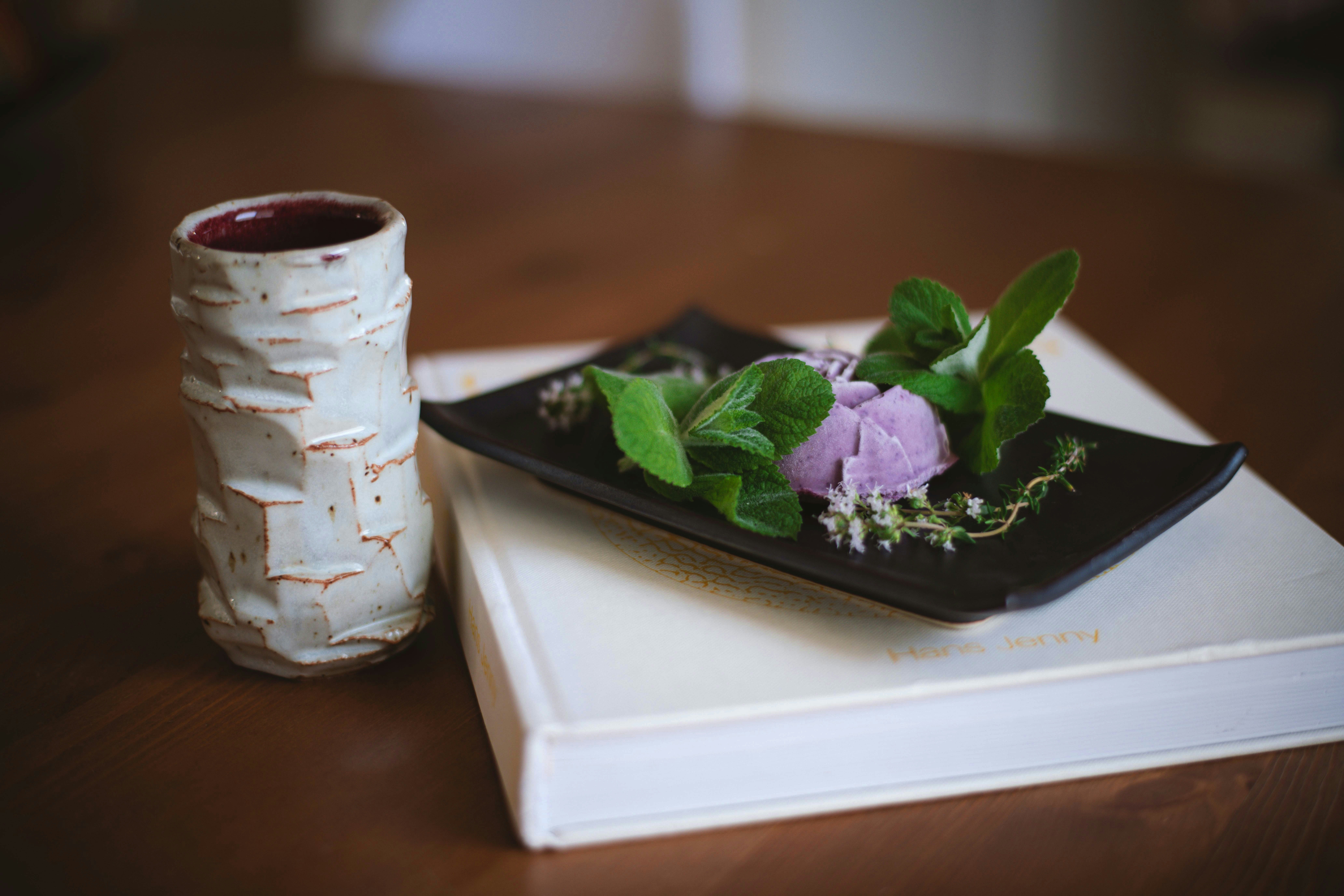 white and black ceramic mug on white ceramic tray