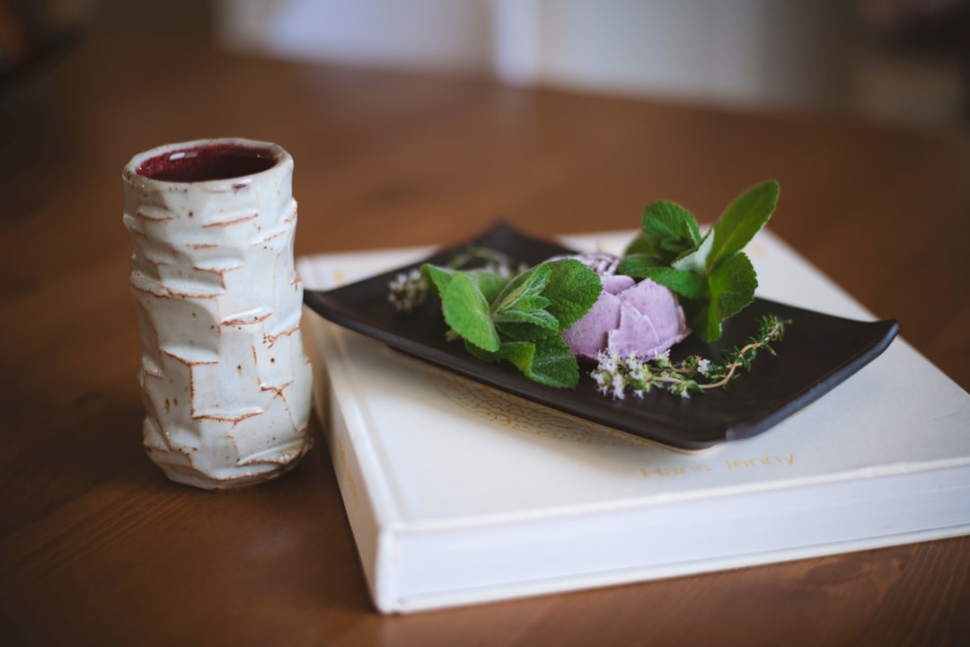 white and black ceramic mug on white ceramic tray