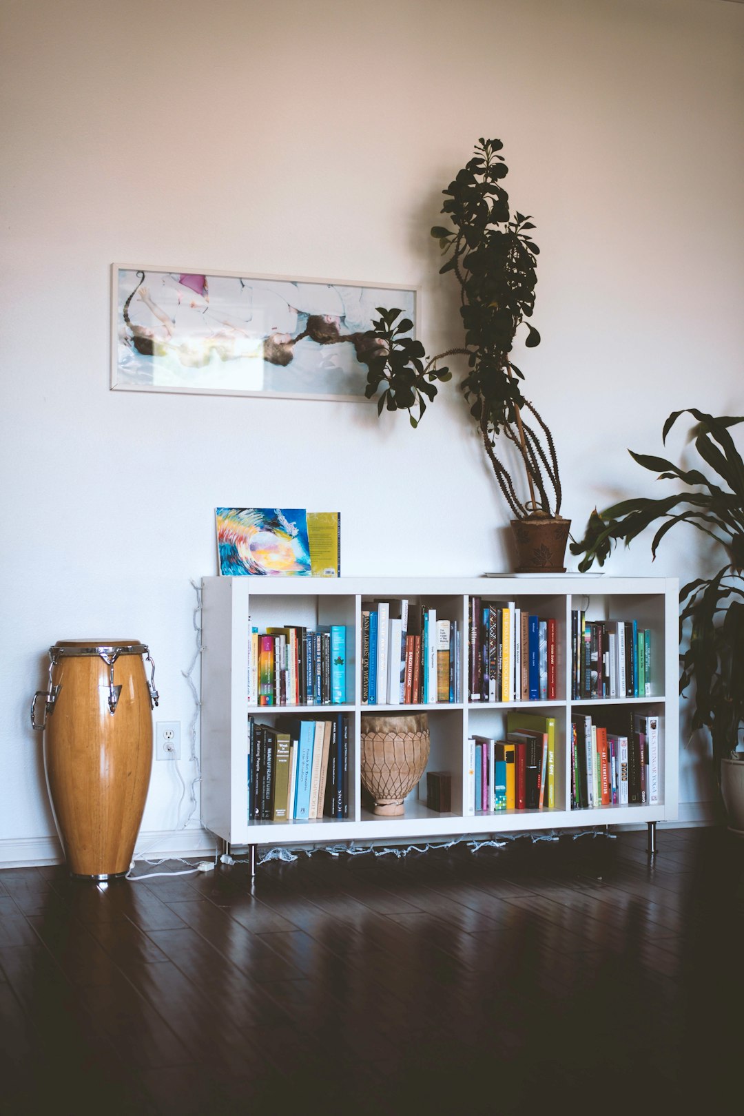 brown ceramic vase on white wooden shelf