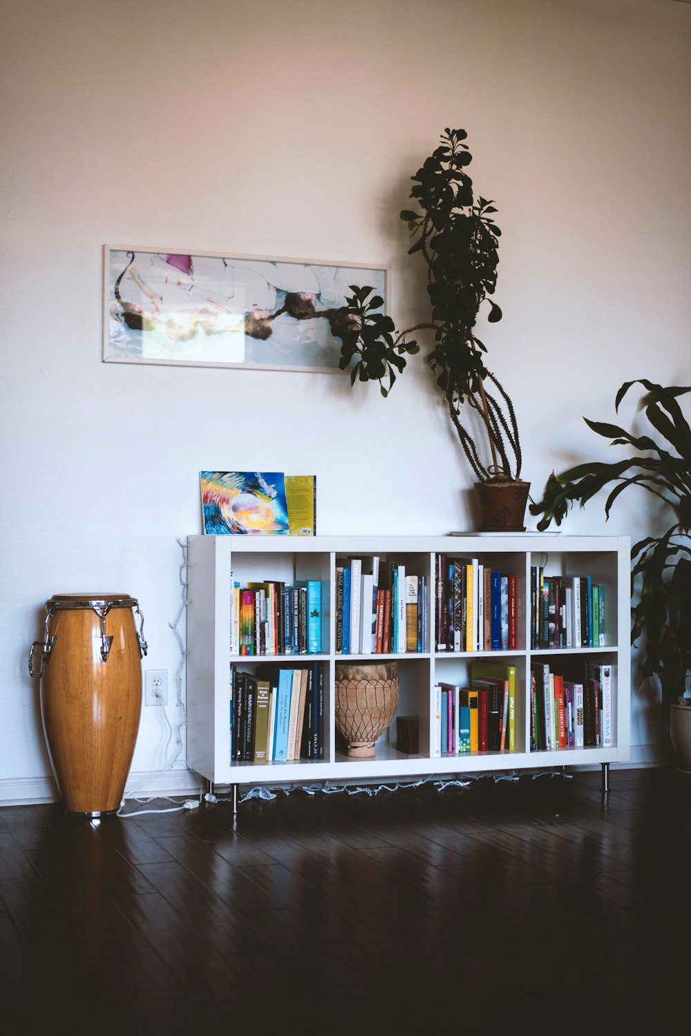 brown ceramic vase on white wooden shelf