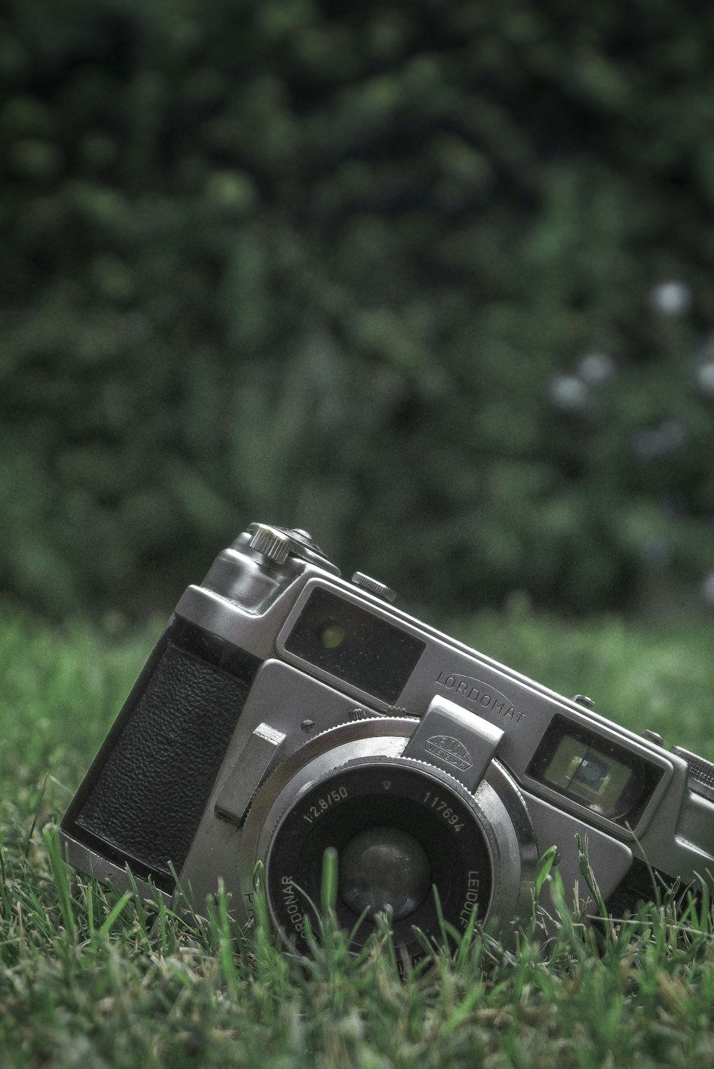 black and silver camera on green grass during daytime