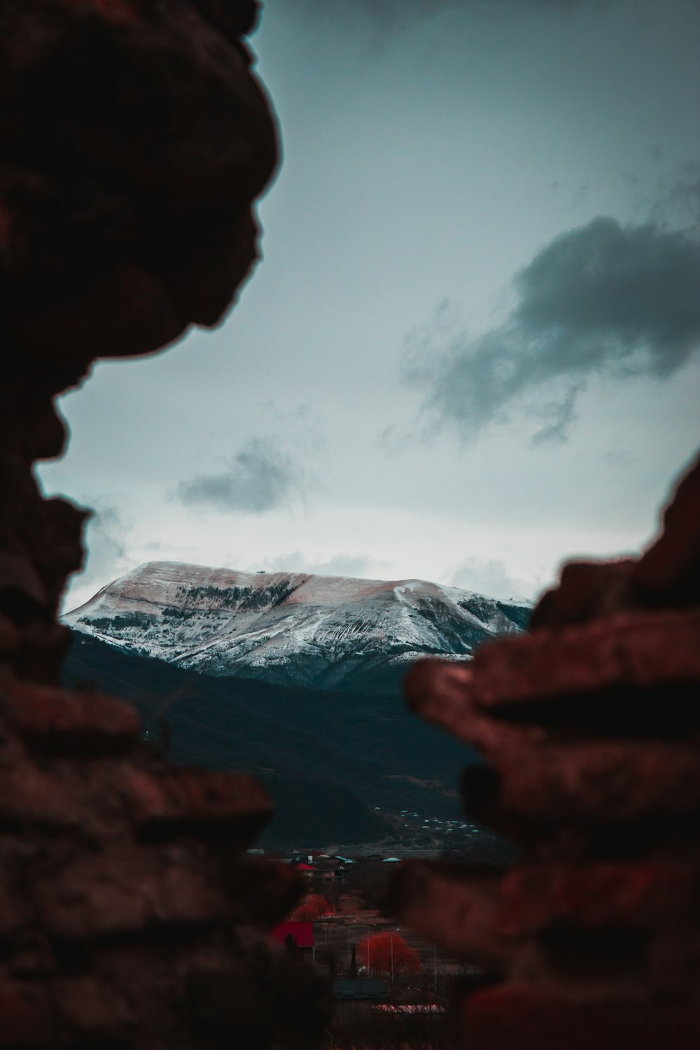 brown rock formation under white clouds during daytime