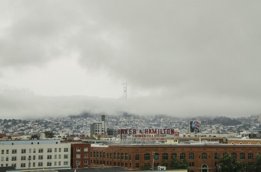 city buildings under white clouds during daytime