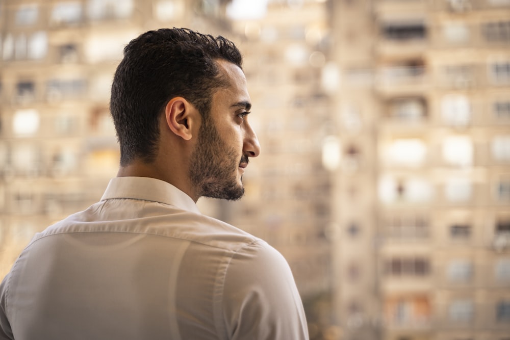 man in white shirt looking down