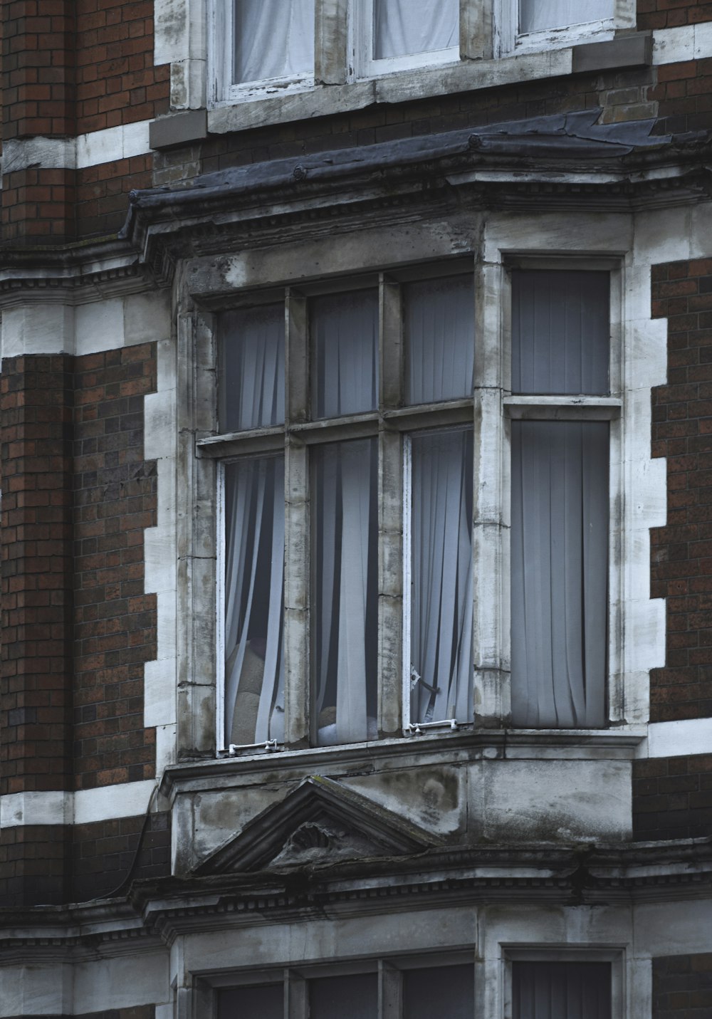 brown brick building with white window