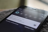 Close-up view of a smartphone screen displaying a notification from the Google Play Store, indicating that the Canon Camera Connect app has been successfully installed. The phone shows a 76% battery charge in the top right corner and several status icons.