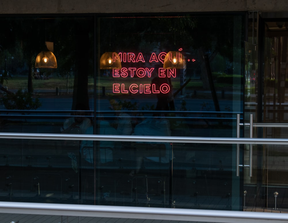 a neon sign in the window of a restaurant