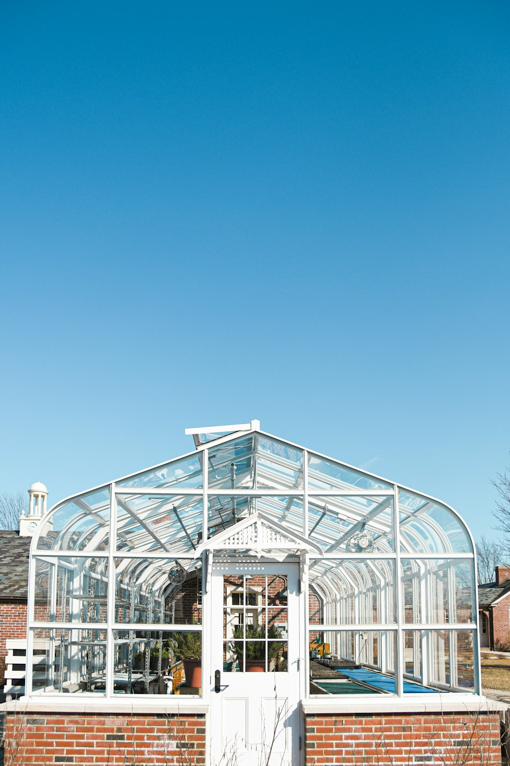 white metal framed glass building under blue sky during daytime