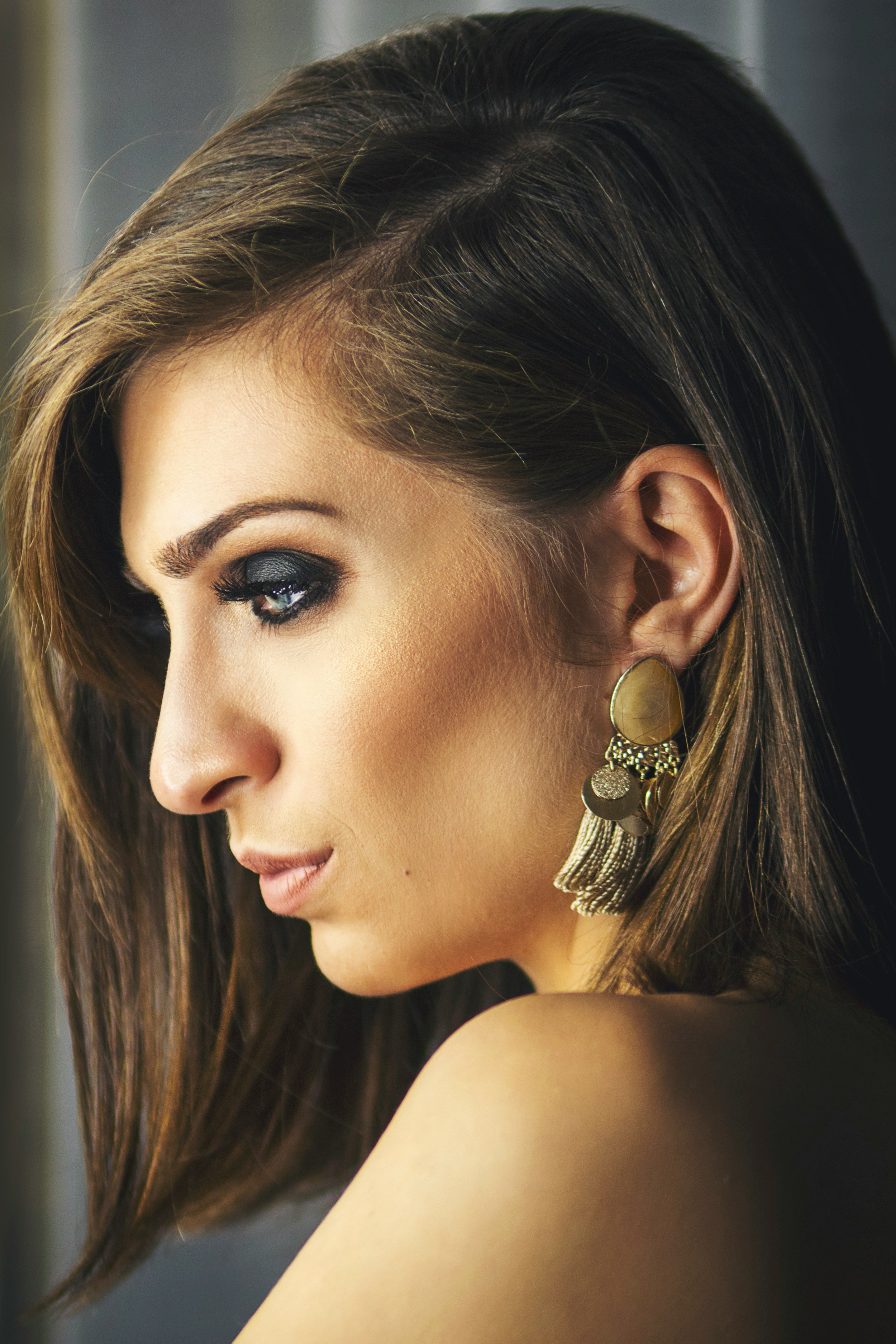 woman with gold and diamond stud earring