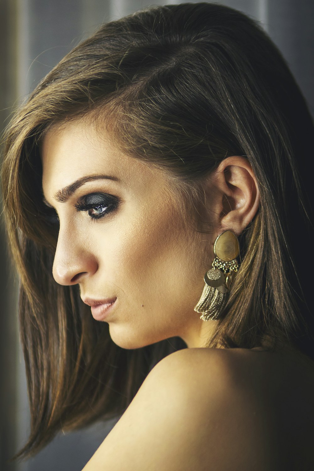 woman with gold and diamond stud earring
