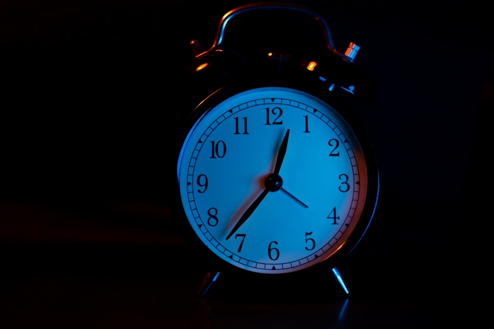 white and silver alarm clock